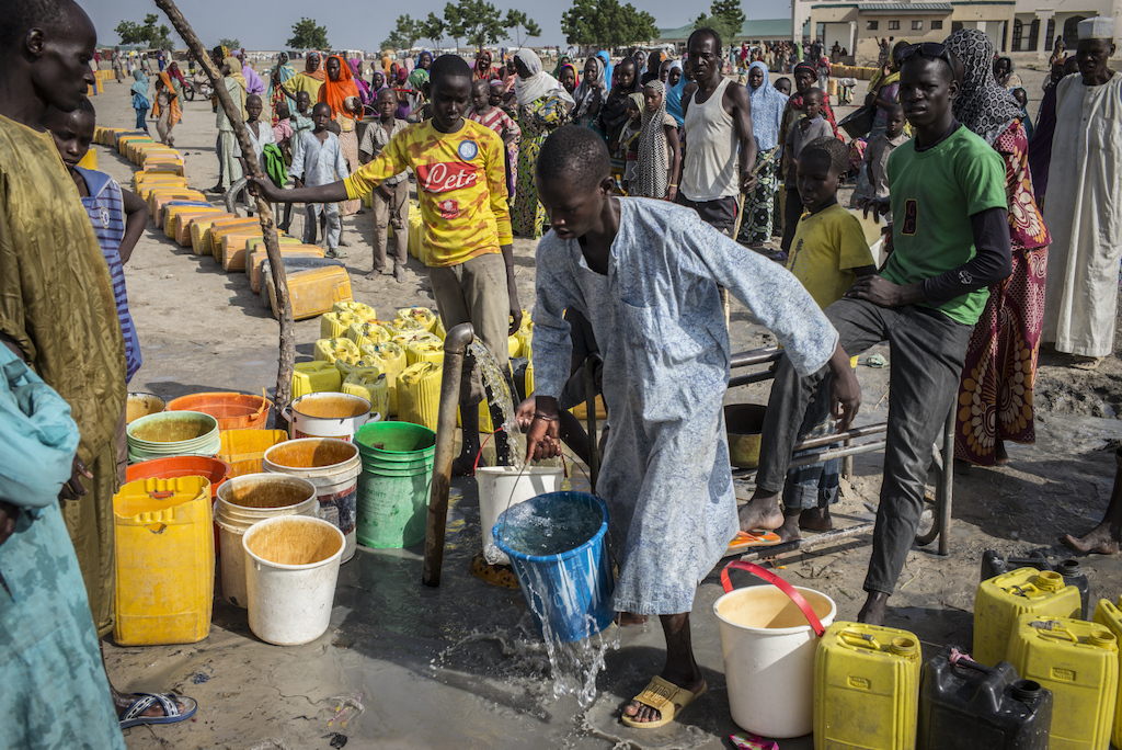 Every morning the camp residents rush to the water point to fill their water buckets. Access to water is a major problem for the displaced. Photographer: Sylvain Cherkaoui