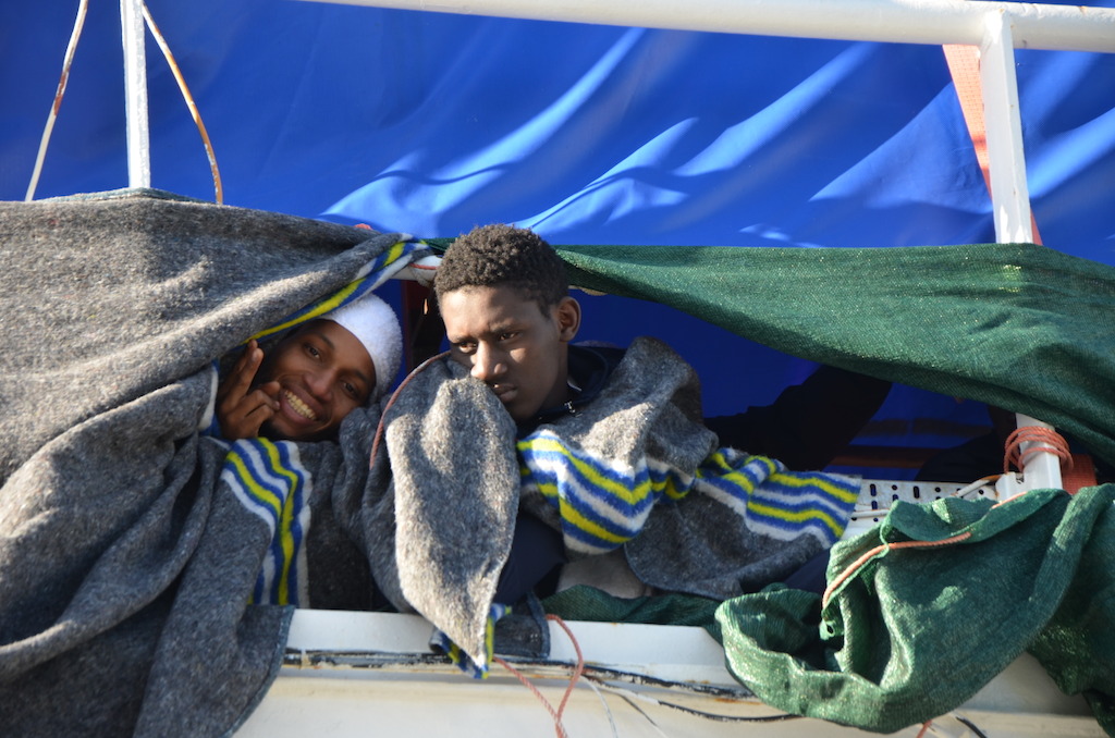 Two rescuees on the top deck of the boat. Photographer: Kate Stegeman