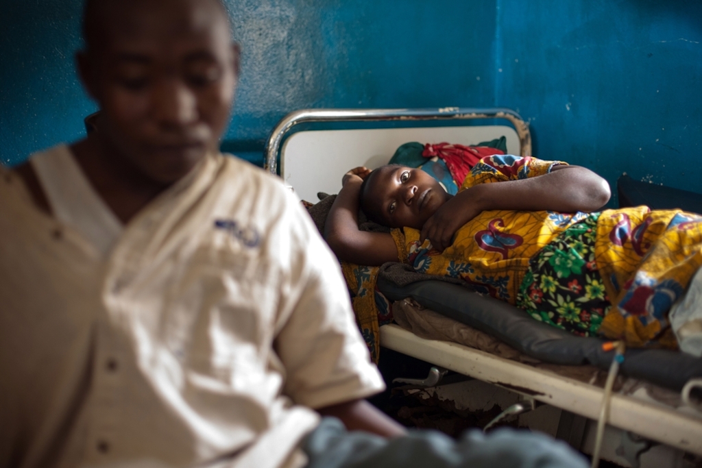A woman is lying on her bed recovering from a caesarian section at Mweso General Hospital on the border between the Masisi and Rutshuru territories in the North Kivu province of the Democratic Republic of the Congo, February 7, 2017. Photographer: Gwenn Dubourthoumieu