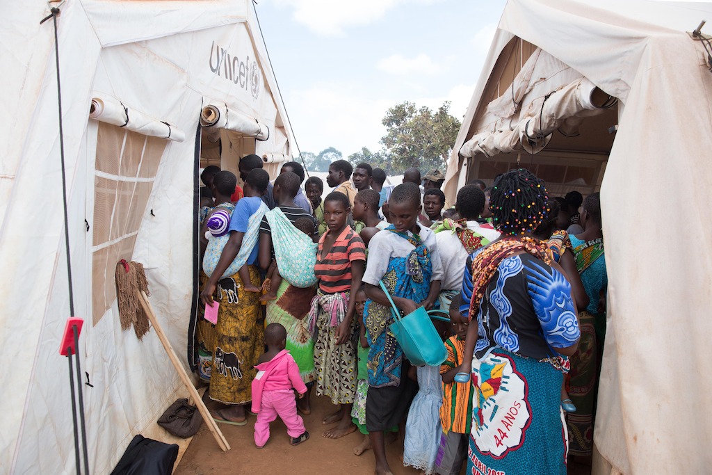 People queue outside a Doctors Without Borders (MSF) clinic. <br/><br/>Over 5.800 Mozambican nationals have camped in the village of Kapise 2 in Malawi after fleeing their homes in Mozambique, the majority of them women, children and the elderly. Half of the consultations in the MSF clinics are malaria cases. © James Oatway / MSF
