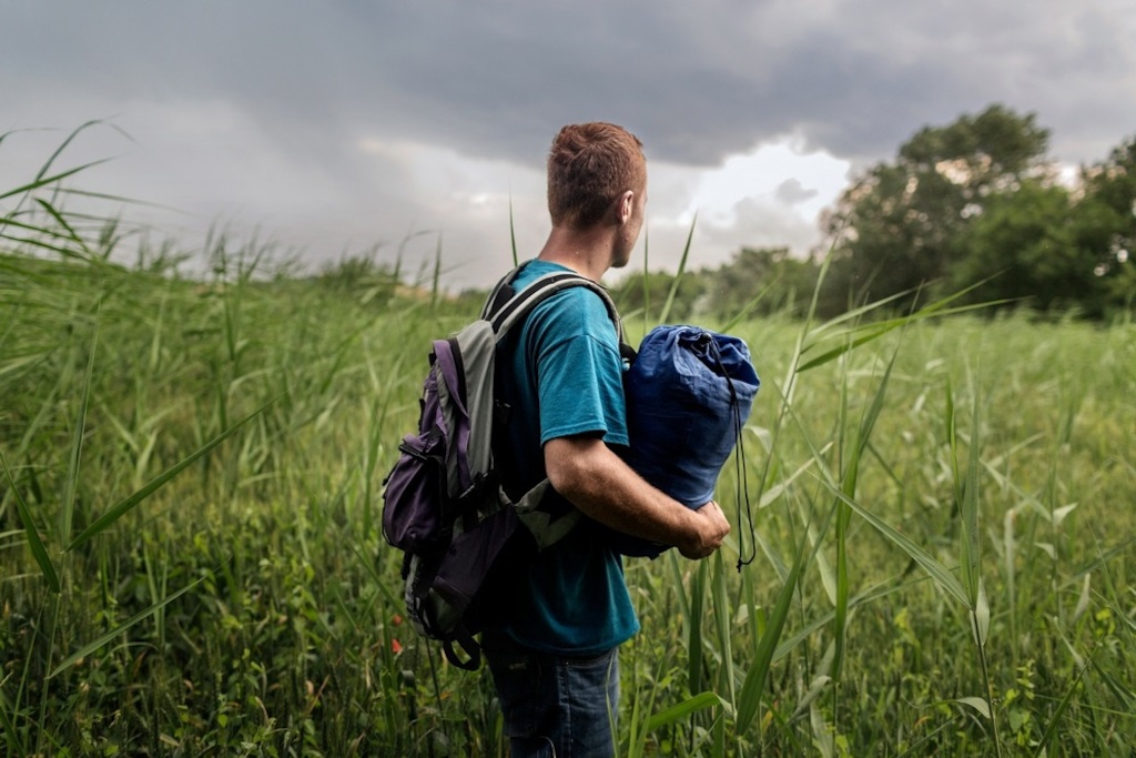 Photographer: Alessandro Penso<br/><br/>Caption: Idomeni. Greece. An Afghan who is around 20 years old on the border of Greece and the Former Yugoslav Republic of Macedonia (FYROM). 'My name is Ayoub, I am 18 years old and I come from Afghanistan. My whole family was killed when I was very young, so I grew up with my uncle. When I was eleven, he was killed too. I then fled to Iran, where I knew some friends. I have walked thousands of kilometres to get here and have used up three pairs of shoes. I only carry a sleeping bag, a few small belongings, something to drink, and something to eat. I must go to Europe, they must help us. In Afghanistan there is no security. Every day people die there.'
