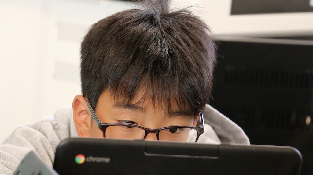 A student at Newport-Mesa USD in California considers his essay using Turnitin Revision Assistant.