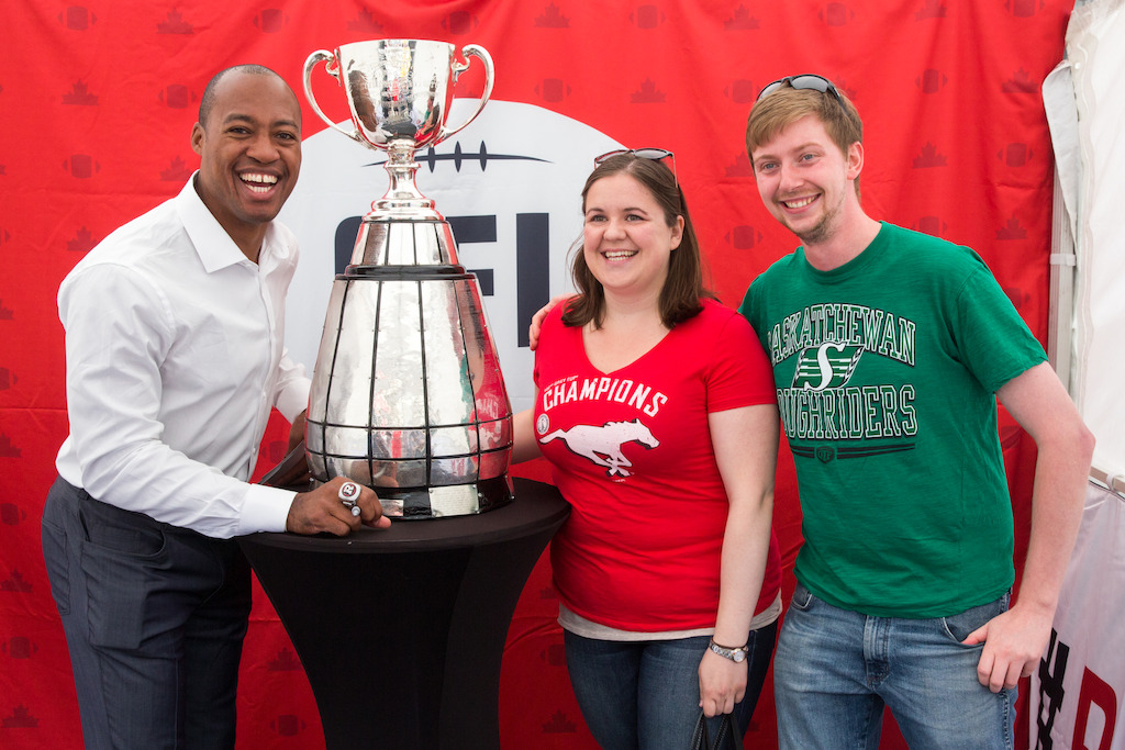 Henry Burris en compagnie de deux partisans de la LCF et de la Coupe Grey. Crédit photo : Jim Ross / LCF.