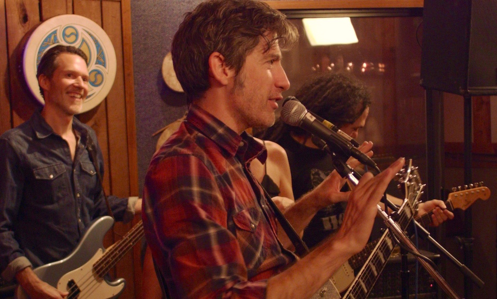 Colin Gilmore and band - still from The Shopkeeper