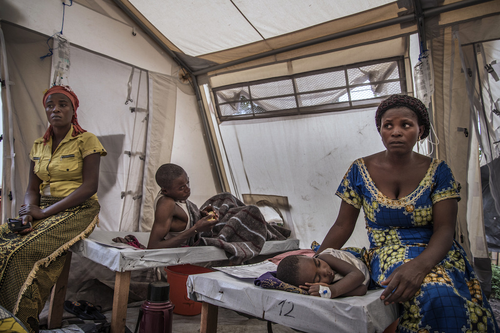 Elisabeth Chihemba sits quietly next to her three-year-old son, Elris Kamo, who is suffering from severe dehydration and is barely able to move. Photographer: Arjun Claire