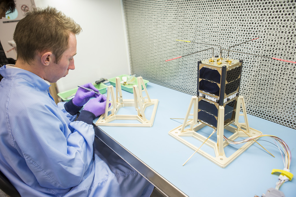 ANU engineer Bart Fordham with one of the Australian CubeSats. Image: Stuart Hay, ANU.