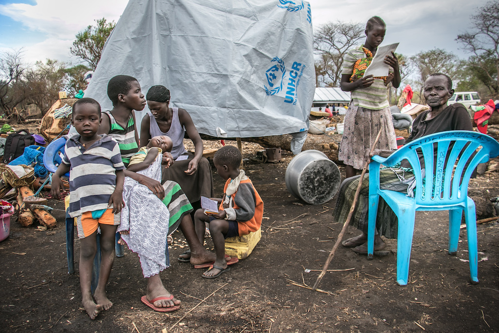 Esther Juru Iin this picture her extended family, including her elderly mother, far right) is a refugee from Kajo Keji, South Sudan. She fled over the border to Uganda after fighting erupted in her home town, and is currently residing in Zone 3, Palorinya refugee camp, where conditions are extremely poor. Her husband was killed during the conflict and she is now looking after her children and elderly mother alone. With no money to buy food or build adequate shelter she is forced to sleep under tarpaulin. Photographer: Fabio Basone/MSF