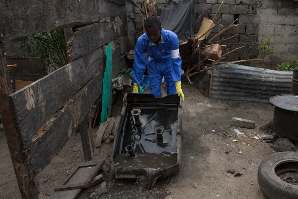 Medecins Sans Frontieres (MSF) staff member empties a water tank in Ndjili area in Kinshasa, during an operation to find and irradiate areas where mosquitoes breed. One case of yellow fever was detected in the neighborhood. Photographer: MSF