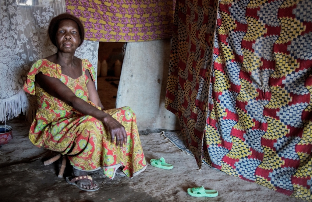 MSF159639<br/>Portrait of 51 year old Martine at a displaced persons camp in Benzvi, Bangui.<br/><br/>Martine, her daughter Calle and granddaughter, Divine are from Bossangoa. They fled after the attack on their home by an armed group who burned all their belongings and killed both Martine’s parents and Calle’s husband. They travelled for three weeks to find refuge in Bangui. They don’t have jobs and to find food is a daily struggle. Those they share the shelter with help them to find food but it is not enough. Divine is not going to school because they cannot find the money for the registration. They want to return to Bossangoa but cannot do so because the trip costs too much. "At night, it is cold in our shelters. We don’t have any blankets. "
