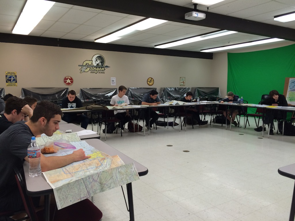 Students at Canyon High School look at maps in their aviation class. Students learn how to read aeronautical charts and practice planning actual flights as a class project.