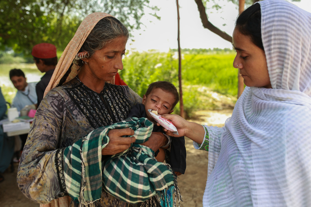 MSF health officer gives plumpy'nut supplement to 1 year old Raiba at the mobile clinic set up at Sikandarabad, district Naseerabad in Balochistan province, Pakistan. Photographer: Sara Farid