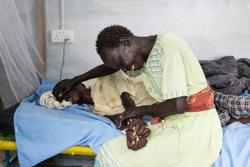 A woman grieves for her sick relative in MSF's hospital in the UN compound in Malakal, South Sudan. Photographer: Anna Surinyach/MSF