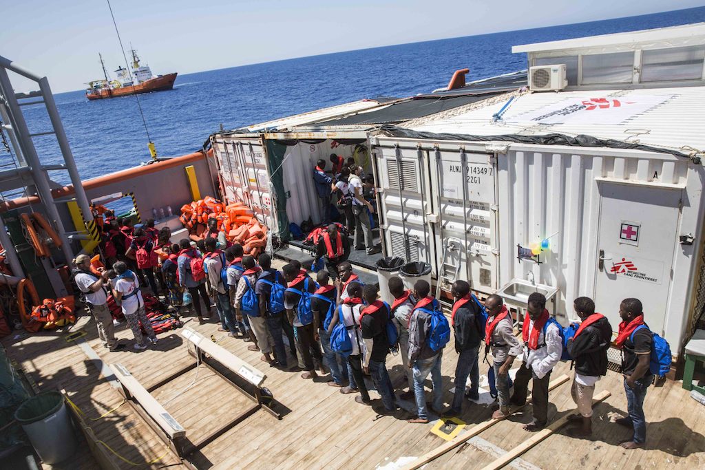 People are transferred from Medecins Sans Frontieres (MSF) search and rescue vessel the Bourbon Argos to the Aquarius (SOS Med in partnership with MSF) in the Mediterranean sea, In total MSF took on board 169 people who were eventually transferred to the Aquarius to begin the journey to port in Italy. Photographer: Andrew McConnell