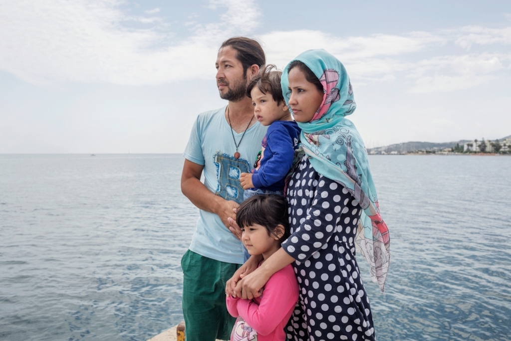 System identifier<br/>: MSF148193<br/>Title<br/>: Migrants in Kos, Greece<br/>Photographer / cameraman<br/>: Alessandro Penso<br/>Countries:<br/>Greece 2015. Kos. Greece. An Afghan family at the pier on the island of Kos. Earlier, they were waiting in vain outside the nearby police station to get the necessary papers which would allow them to leave the island. “I’ve come to Europe to give my children the best” says the father of the family. “I don’t know when I can get my papers.”. For seven days, the family was staying in the disused Captain Elias hotel, which the Kos authorities direct migrants to stay in while they await the authorization from the police to leave the island. However, they decided to move out because of the unhygienic conditions: “It’s dangerous for the children because there are a lot of insects.`My children have insect bites all over their bodies. When I was sleeping there was an insect that crawled into my ear and it’s still there now.”