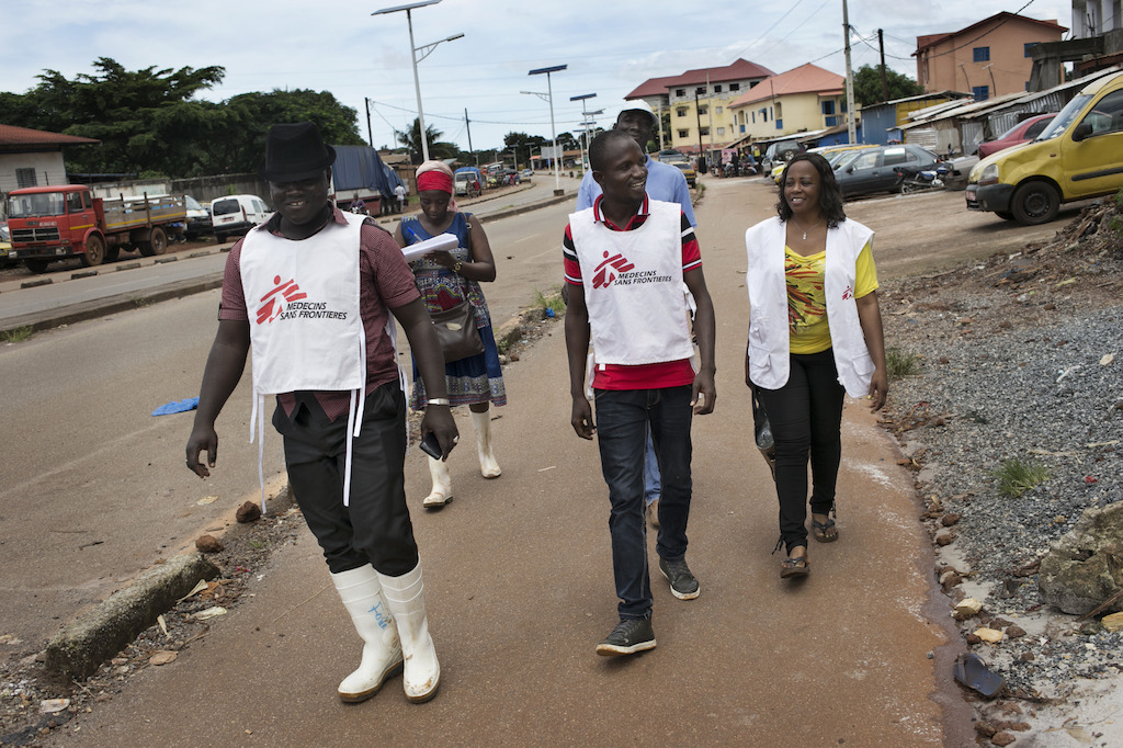 Health Promotion (HP) teams walk down the street of Yattaya Fossidé neighbourhood while conducting activities against the sigmatisation of Ebola survivors with the local population in Conakry. <br/><br/>(from left to right: Fodé Soumah, Camara Djenab, Cécé Dominique Delamou and Angeline Teinguiano). Photographer: Albert Masias
