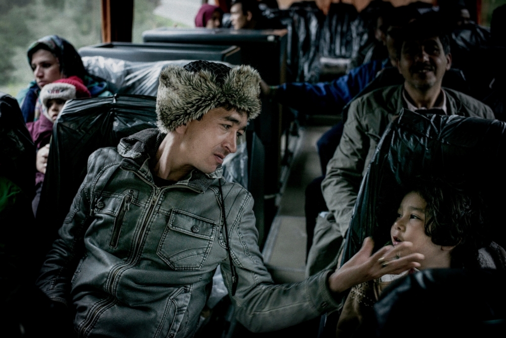 Mirza Hossain, from Afghanistan, travels with his family by bus to the ferry terminal on the island of Samos, from where they plan to travel on to Piraeus, on mainland Greece. MSF had stepped in to provide hotel accommodation for eight families from Afghanistan and Syria who were left without shelter on the island as a storm approached. Photographer: Guillaume Binet/MYOP